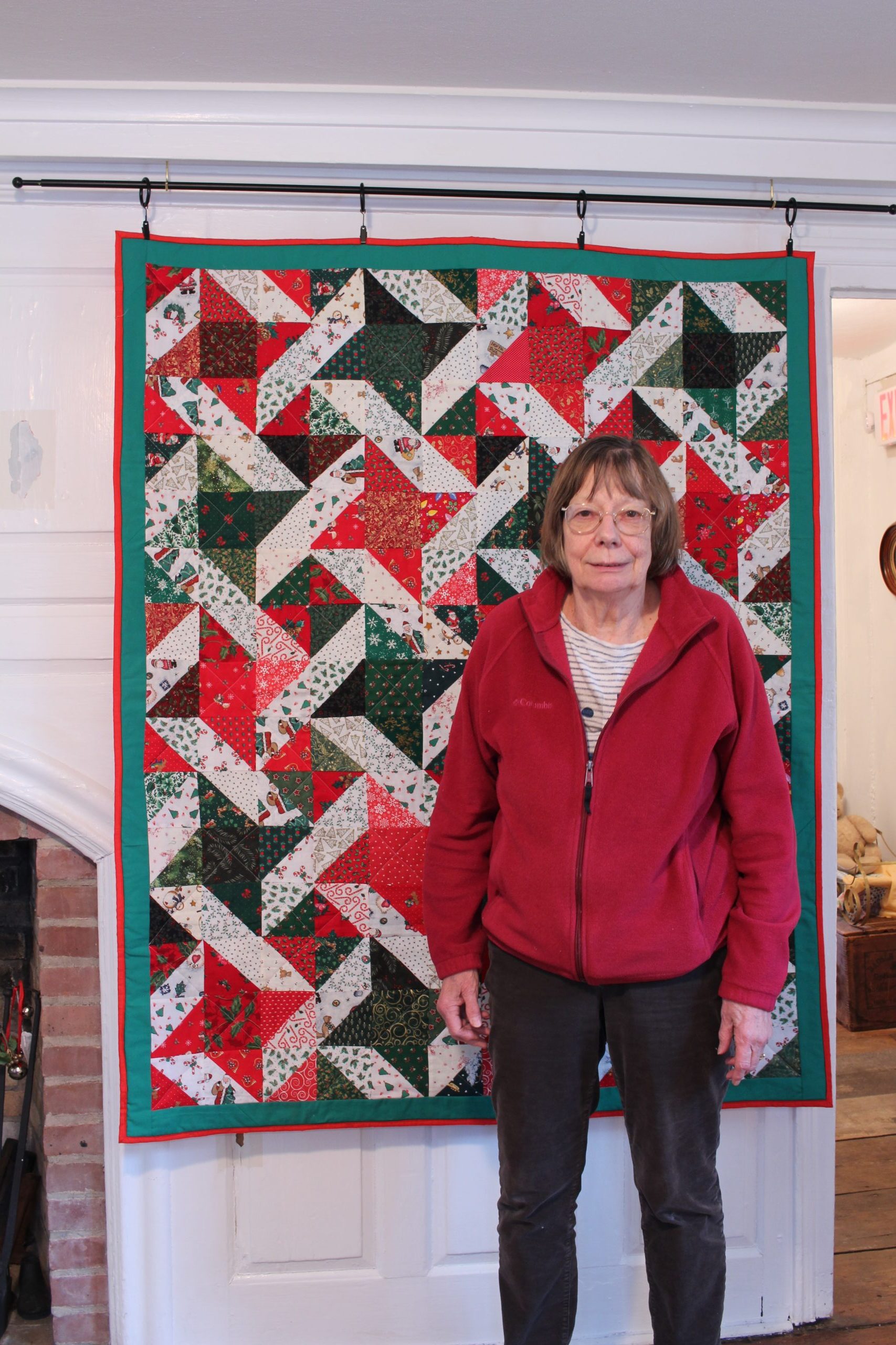 Marianne Moerkens of the Oxford Garden Club and the holiday quilt she donated to the Oxford Historical Society.