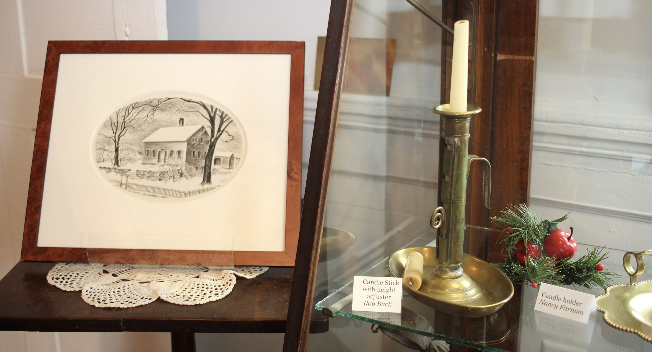 An adjustable height candlestand and print of Petticoat Farm